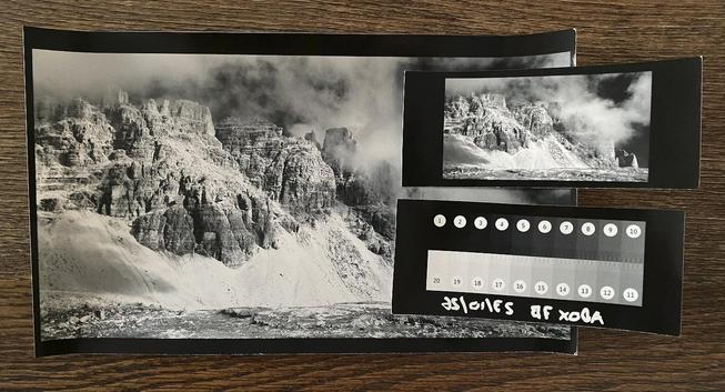 Some B&W baryta test prints of different sizes lying on a table